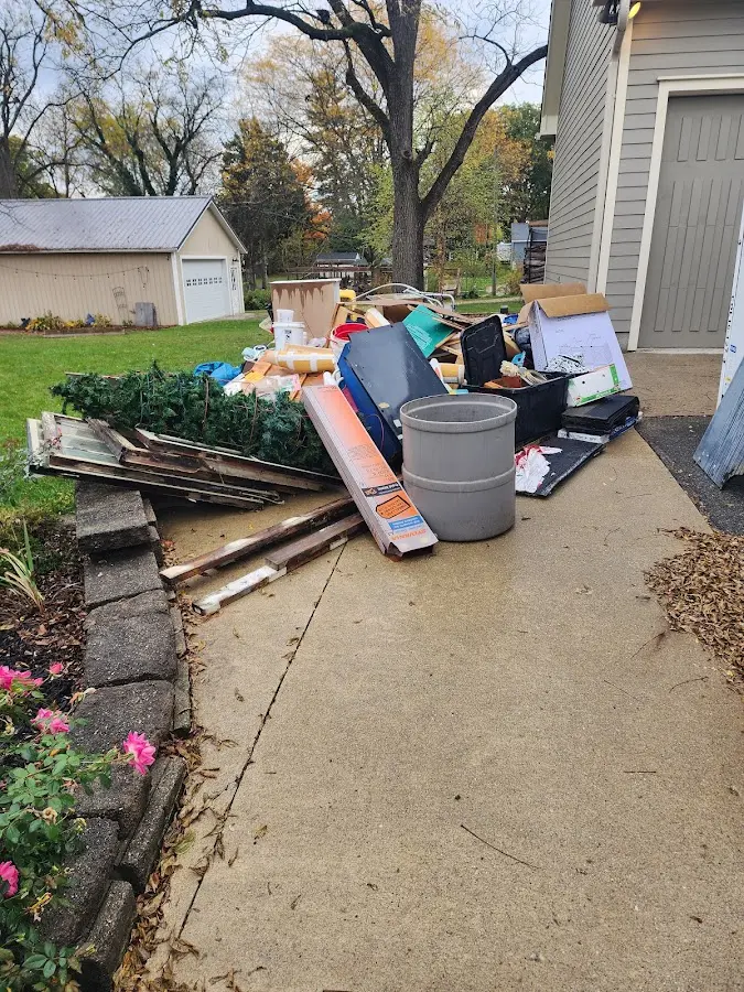 Dumpster being loaded with debris for Roofing Dumpster Rental in Barrington